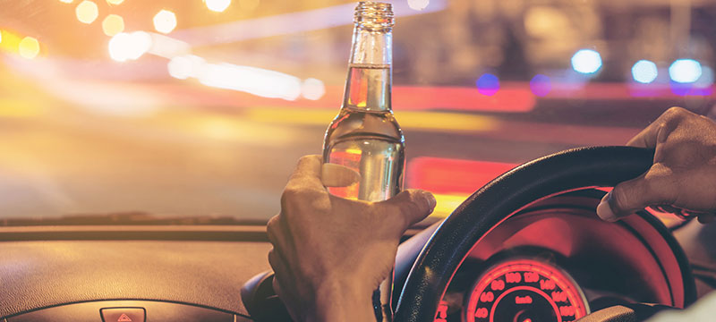 Person holding a beer while driving