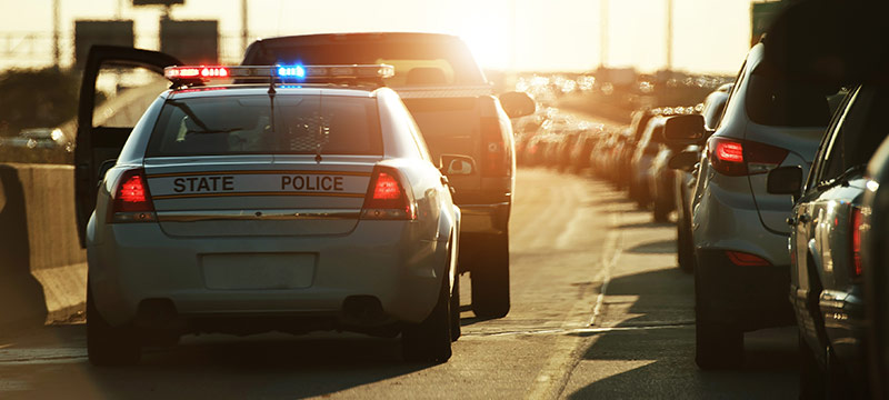 Cop pulling over someone on the highway