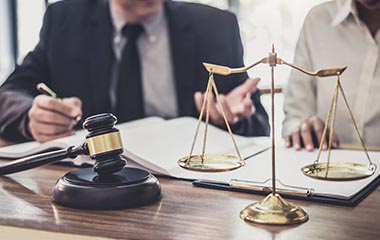 Lawyer and client looking at documents on a desk