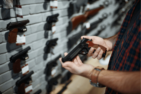 Person with a felony browsing guns at a gun shop