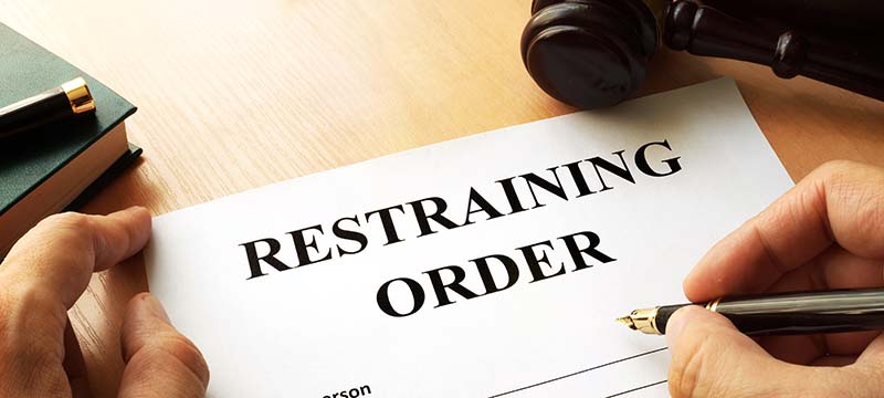 Person signing a restraining order