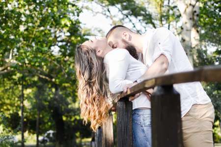 Two fully clothed people kissing in public