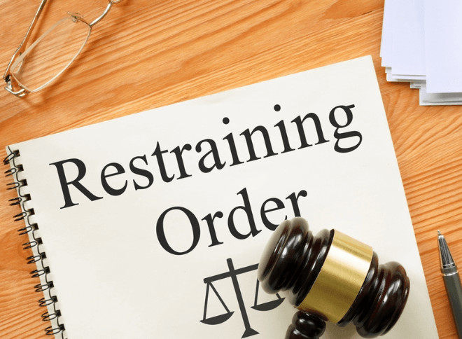 A lawyer writing on a Florida restraining order