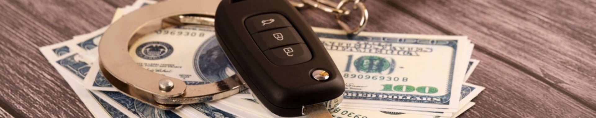 hundred dollar bills with handcuffs and car keys
